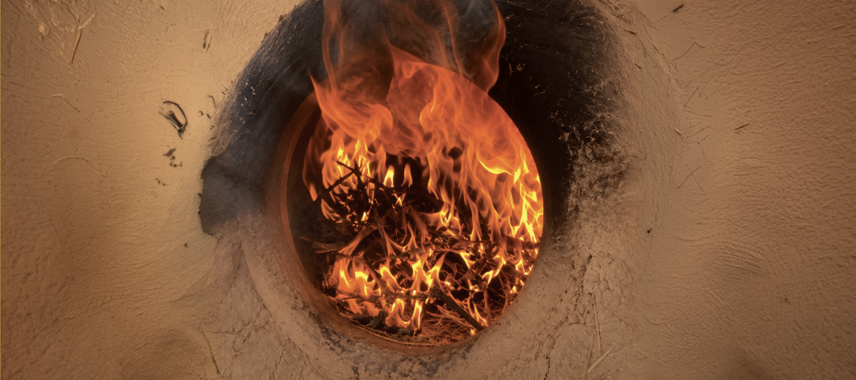 Fire burning inside a clay bhatti oven